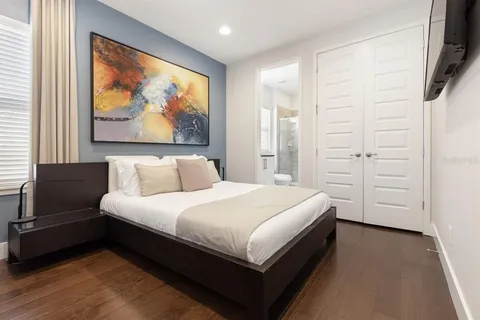 a spacious bedroom with a bed and a window