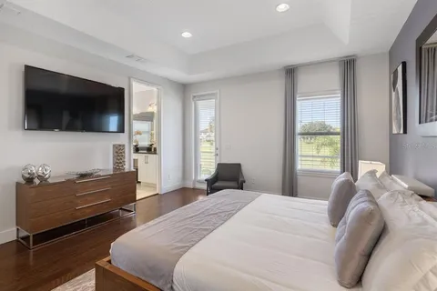 a bedroom with a bed and a flat screen tv