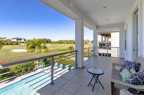 a view of a balcony with table and chairs and wooden floor