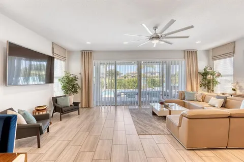 a living room with furniture and large windows