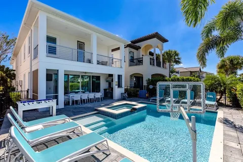 a view of an house with backyard porch and swimming pool