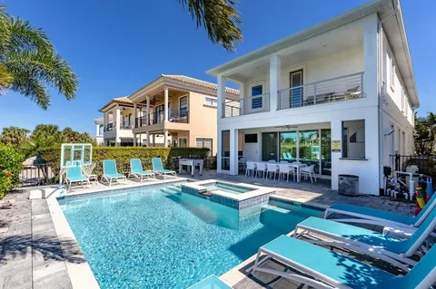 a view of a house with swimming pool and sitting area