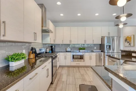 a kitchen with a sink and white cabinets