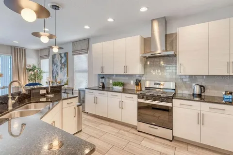 a kitchen with a sink window and cabinets