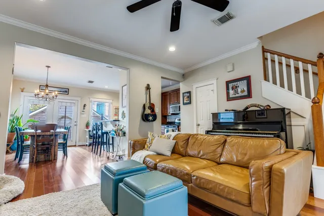 a living room with furniture and a wooden floor