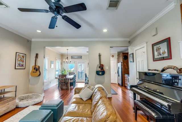 a living room with furniture and wooden floor