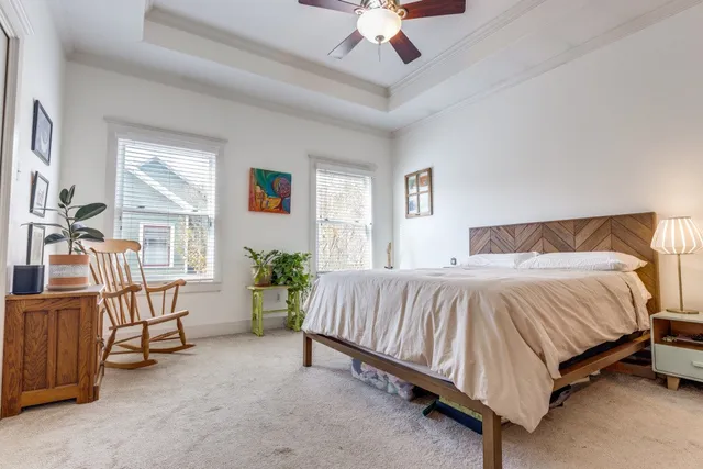 a spacious bedroom with a bed couch and a window