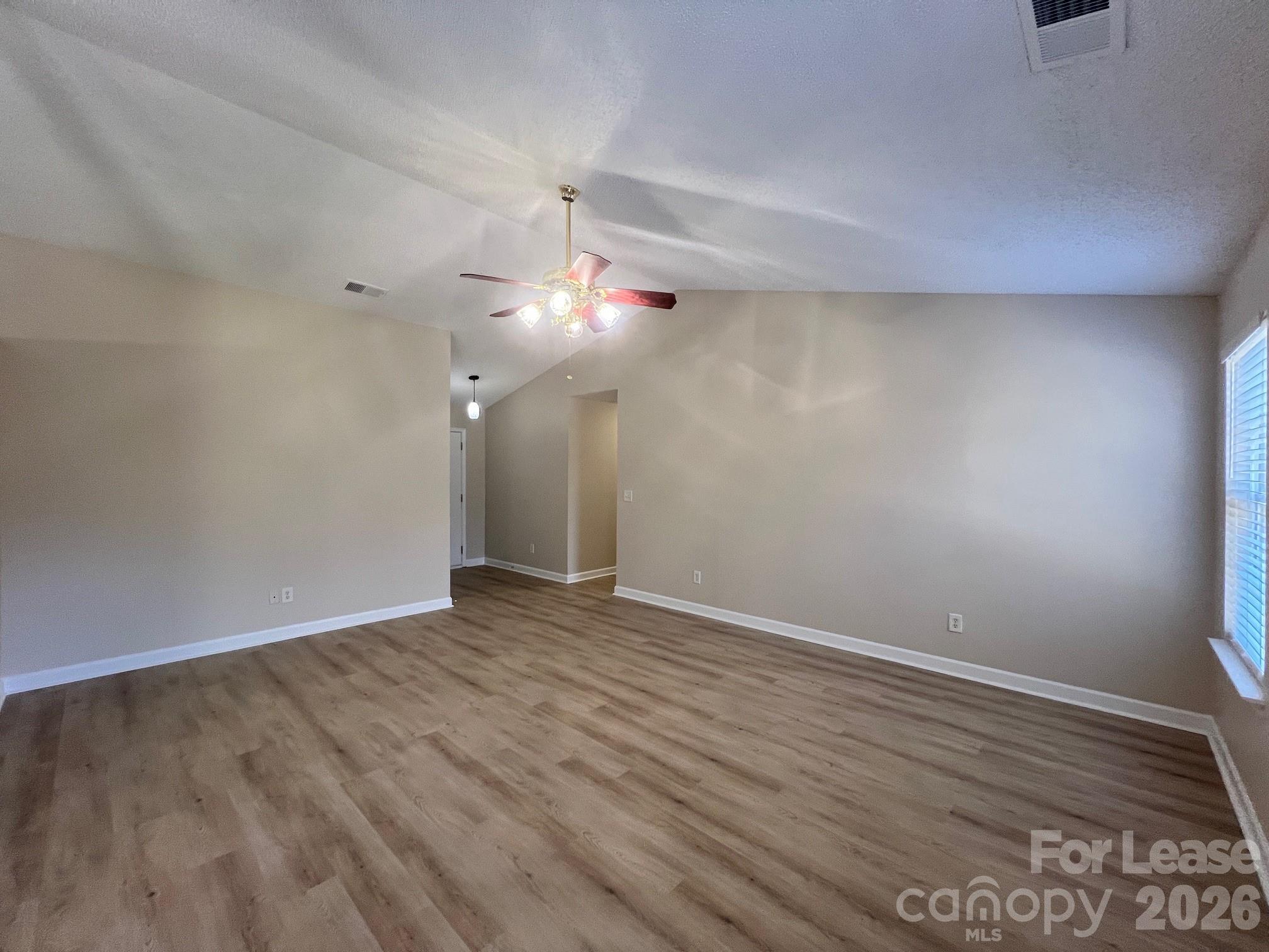 2616 Captains Watch Road Northeast Kannapolis, NC 28083 - Photo 5 of 25 a view of an empty room with wooden floor