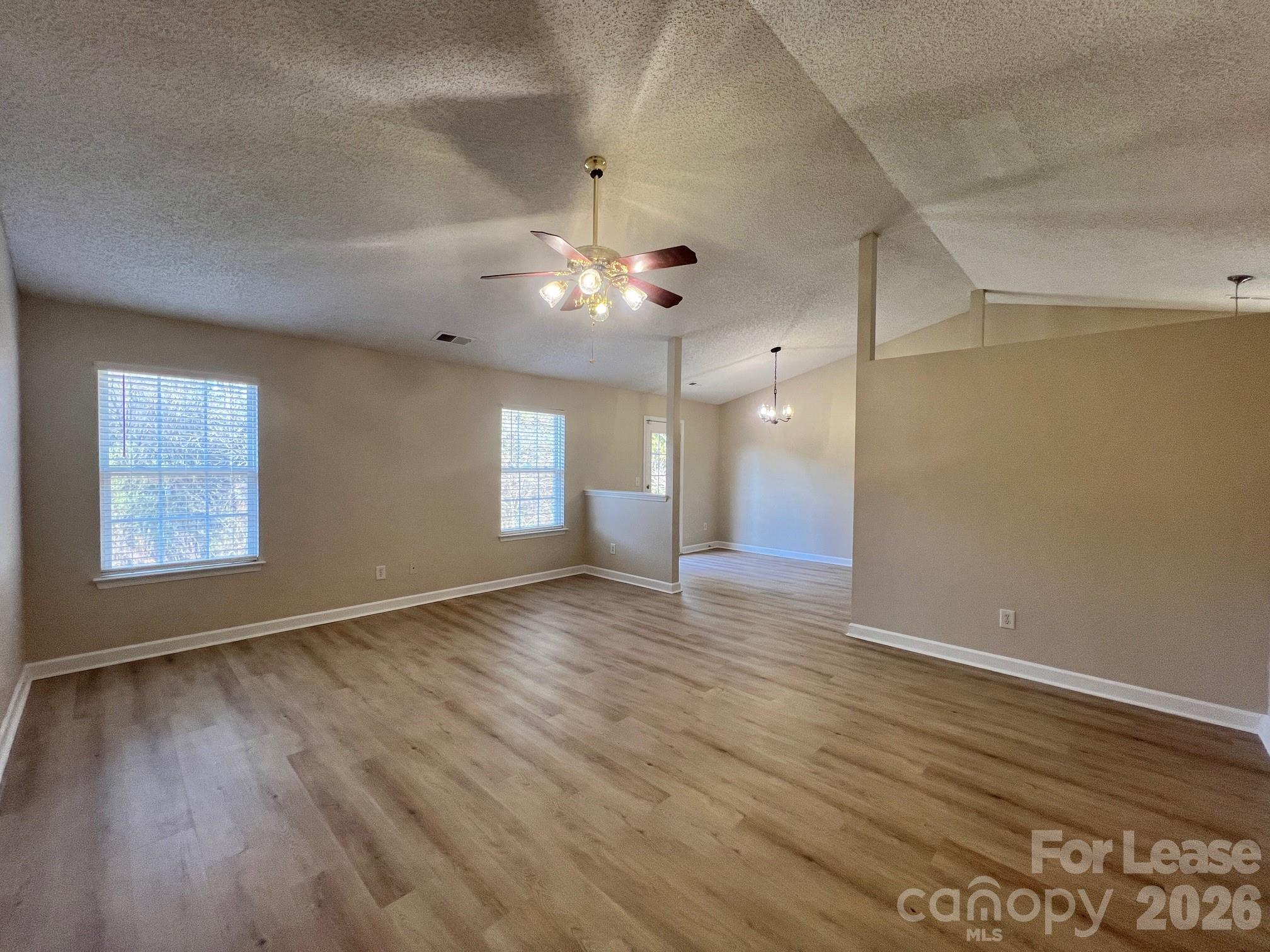 2616 Captains Watch Road Northeast Kannapolis, NC 28083 - Photo 6 of 25 wooden floor in an empty room with a window