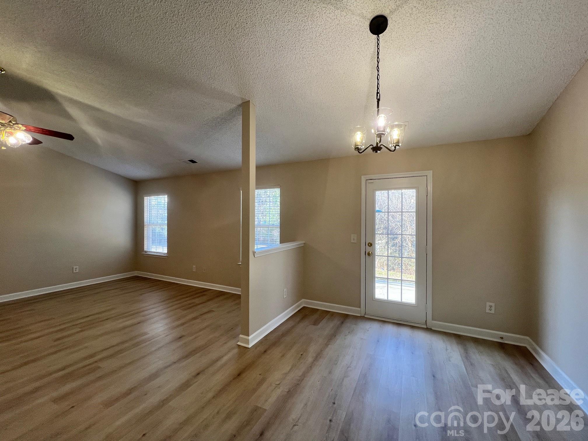 2616 Captains Watch Road Northeast Kannapolis, NC 28083 - Photo 8 of 25 an empty room with wooden floor and windows