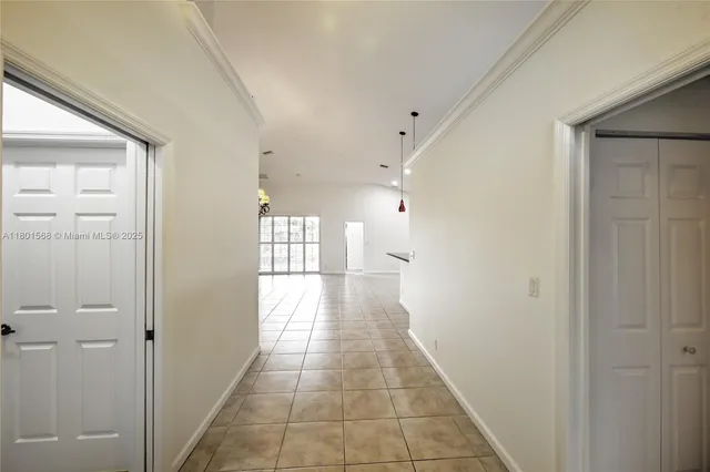 a view of a hallway with a chandelier