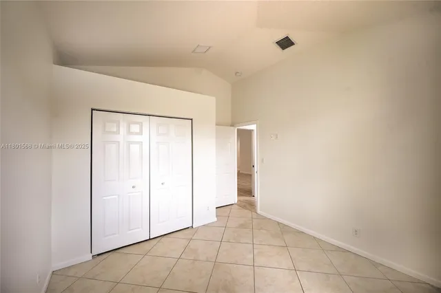 a view of a room with wooden floor and a ceiling fan