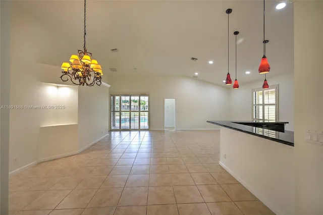 a view of kitchen and kitchen with stainless steel appliances wooden floor