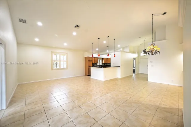 a kitchen with stainless steel appliances granite countertop a sink and a refrigerator