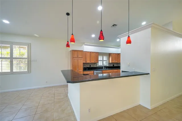 a kitchen with stainless steel appliances granite countertop a stove and a refrigerator