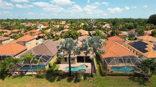 an aerial view of residential houses with outdoor space and ocean view