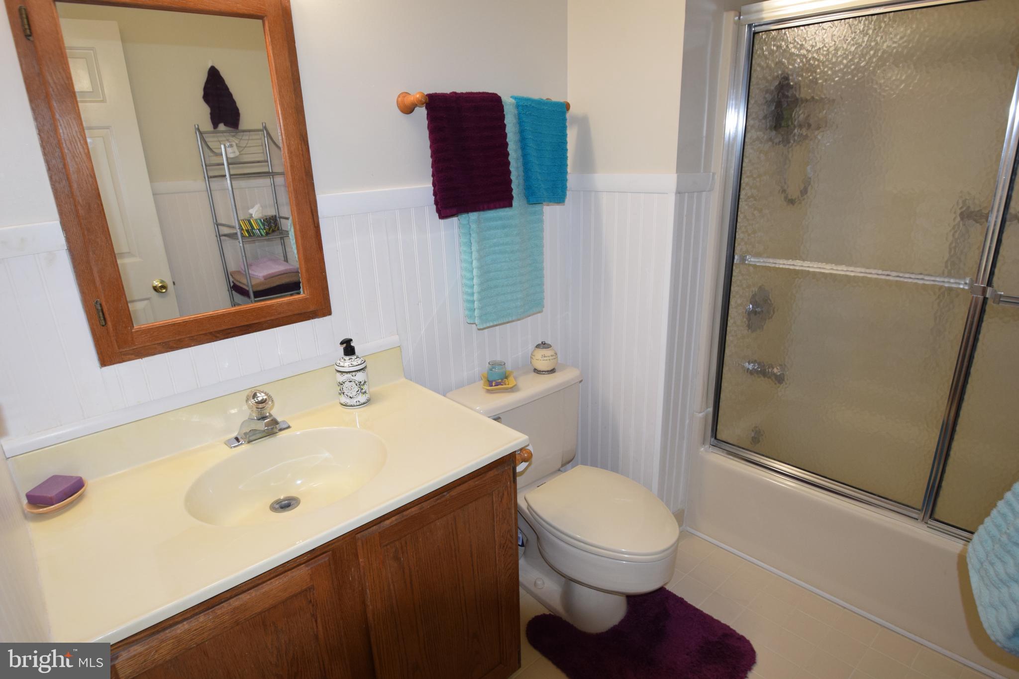 129 Woodhill Road Wilmington, DE 19809 - Photo 15 of 25 a bathroom with a sink and a mirror