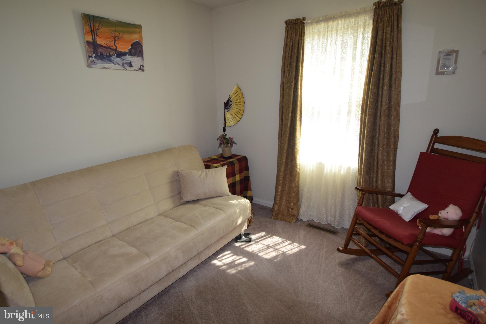 129 Woodhill Road Wilmington, DE 19809 - Photo 17 of 25 a bed room with a bed and a couch