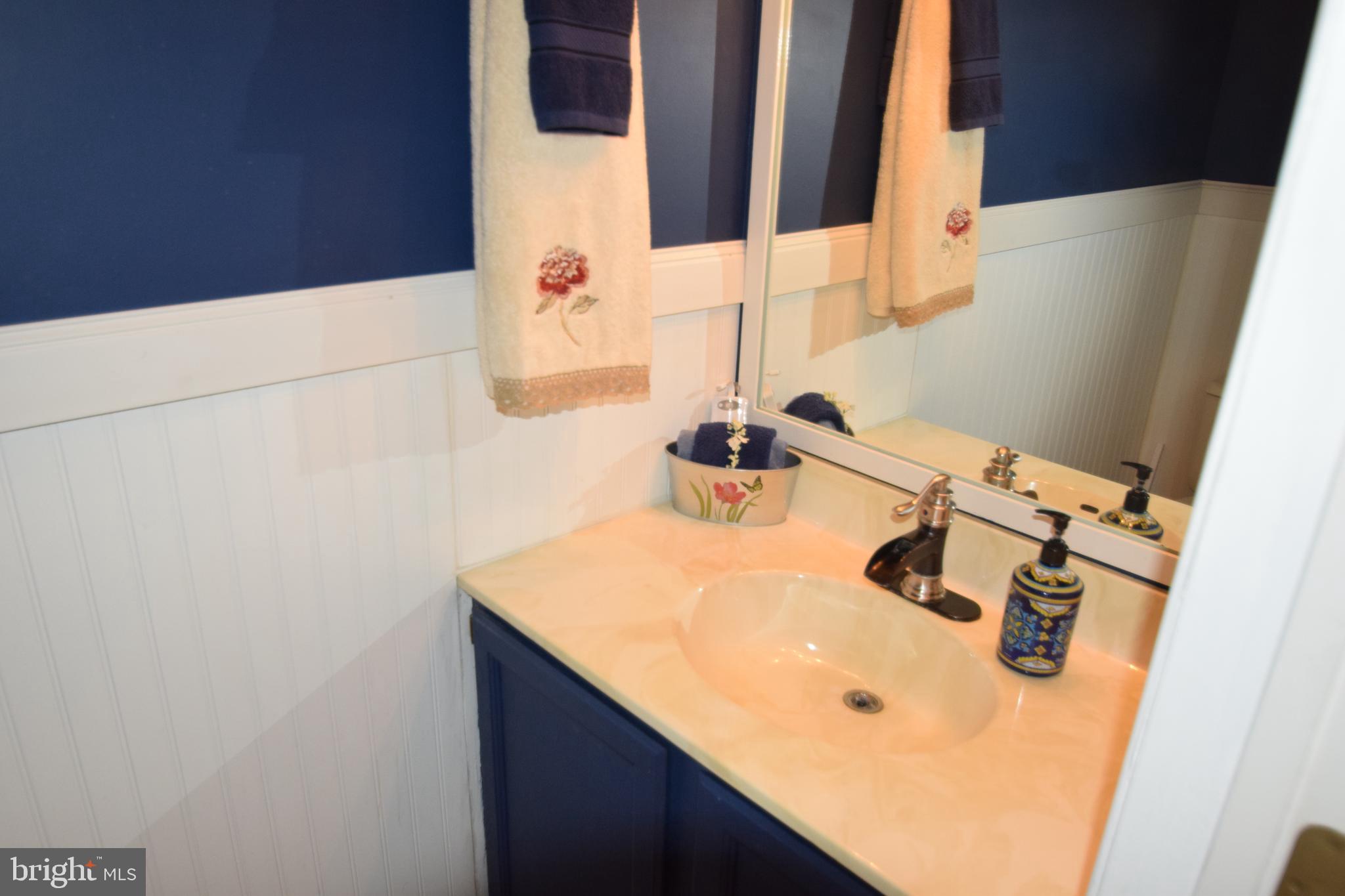 129 Woodhill Road Wilmington, DE 19809 - Photo 18 of 25 a bathroom with a sink and a mirror