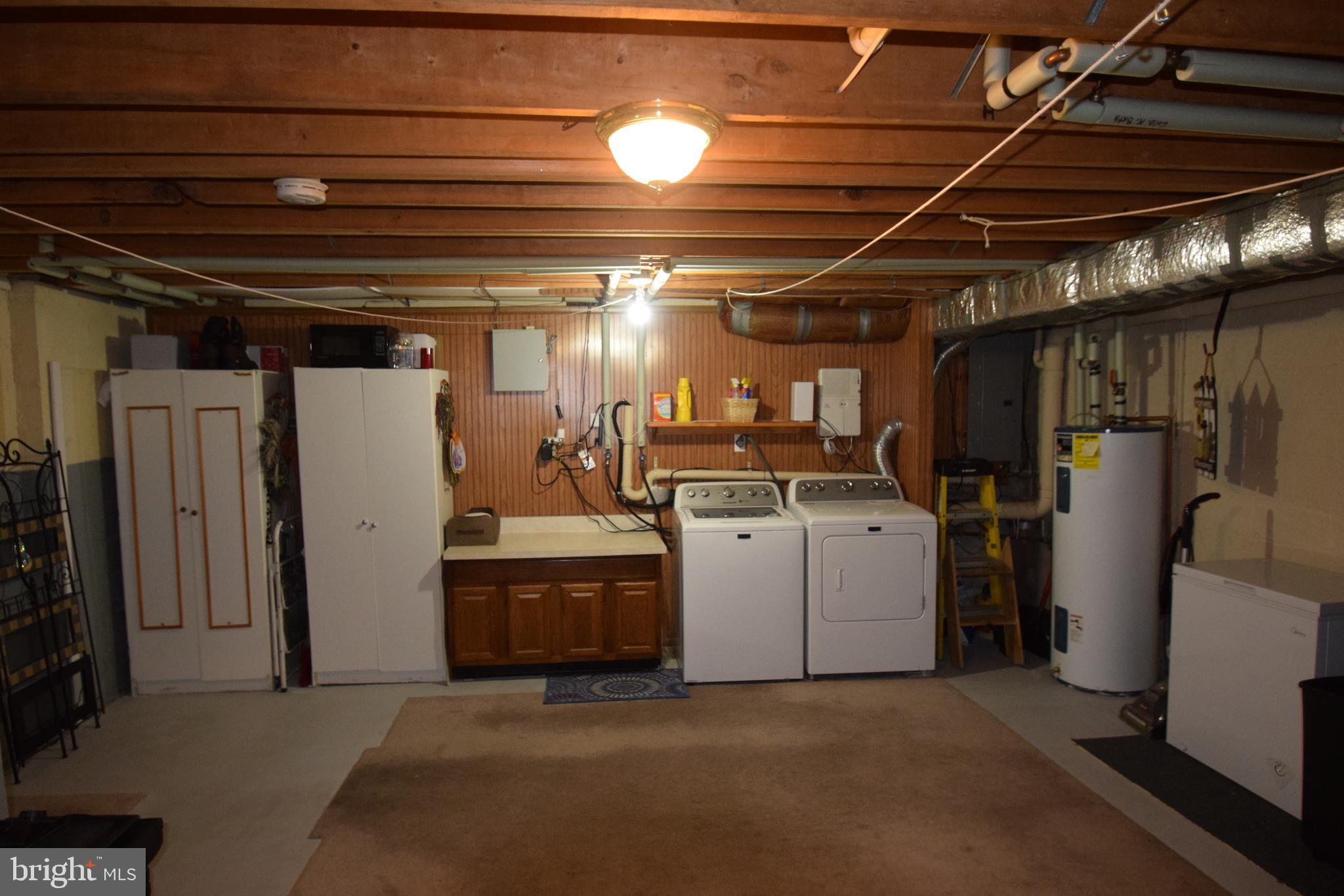129 Woodhill Road Wilmington, DE 19809 - Photo 22 of 25 a view of storage and utility room with refrigerator and washer