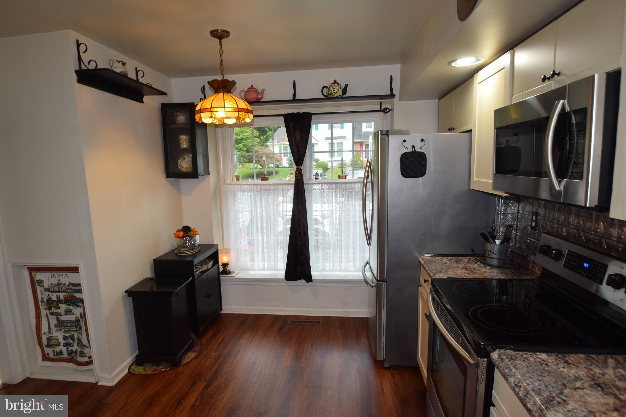 129 Woodhill Road Wilmington, DE 19809 - Photo 5 of 25 a kitchen with stainless steel appliances granite countertop a stove a sink and a refrigerator