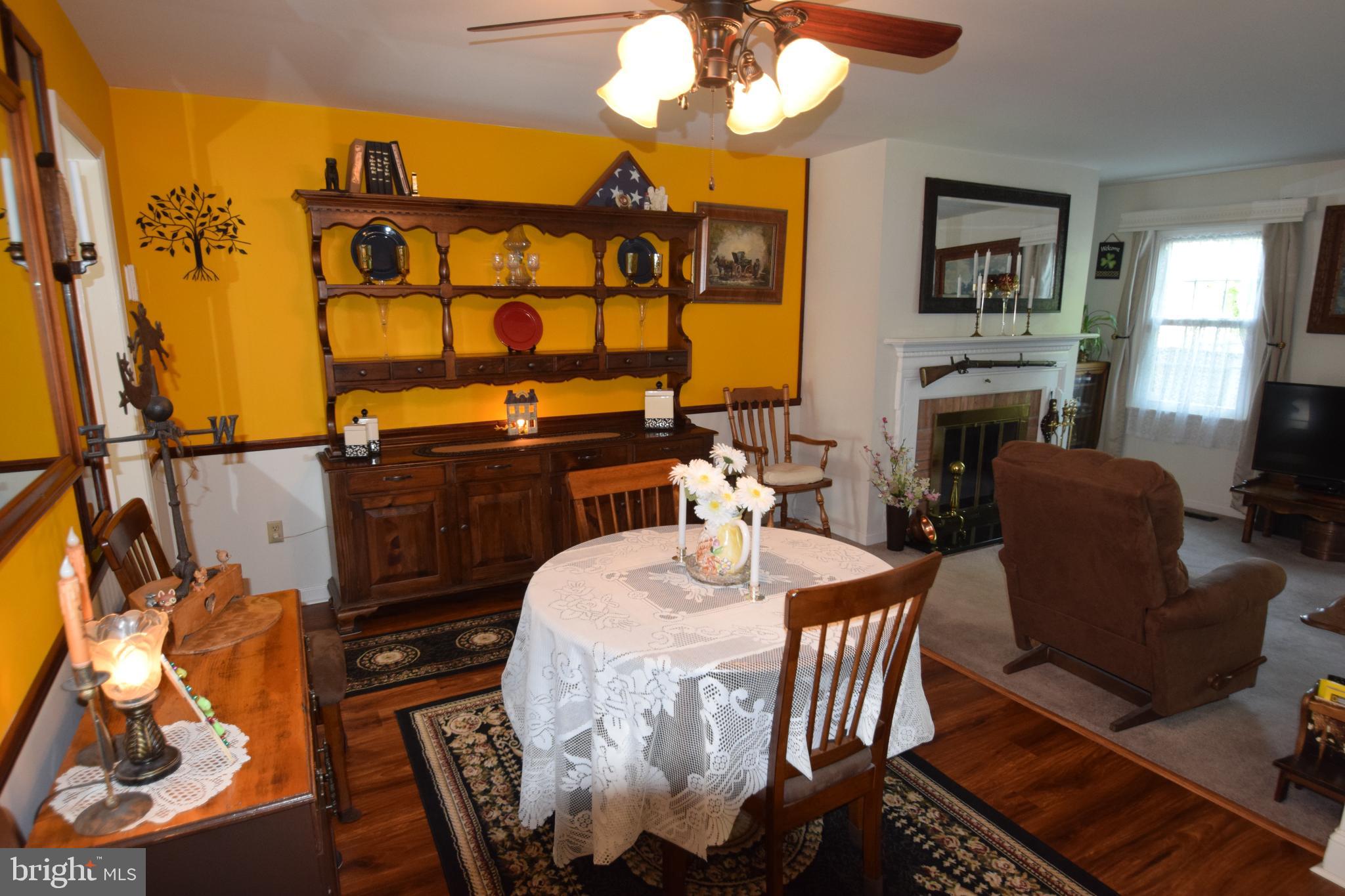 129 Woodhill Road Wilmington, DE 19809 - Photo 7 of 25 a dining room with furniture a flat screen tv and a fireplace