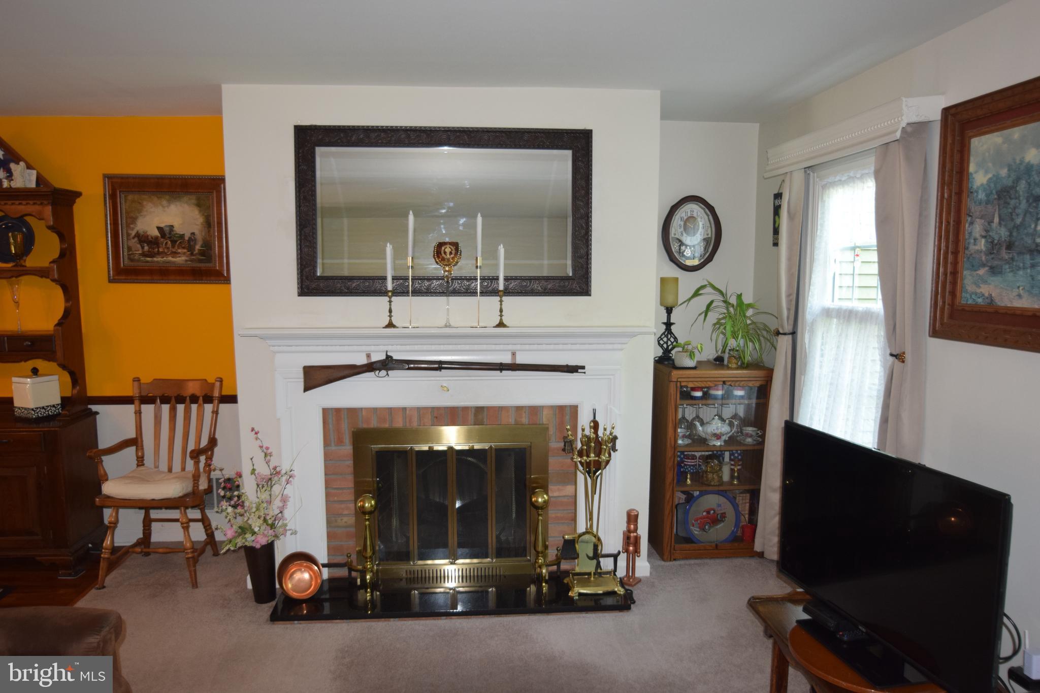 129 Woodhill Road Wilmington, DE 19809 - Photo 10 of 25 a living room with furniture and a fireplace