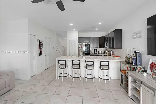 a kitchen with white cabinets a sink and appliances