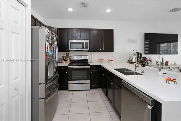a kitchen with a sink and stainless steel appliances
