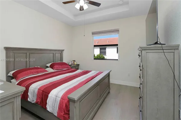 a bedroom with a bed and a chandelier