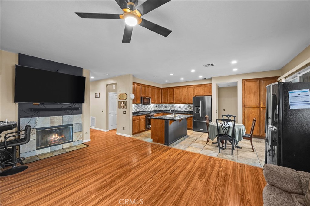 150 Saddleback Way Perris, CA 92570 - Photo 12 of 46 a living room with fireplace furniture and a flat screen tv