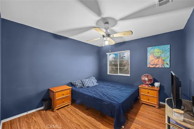 a bedroom with a bed and wooden floor