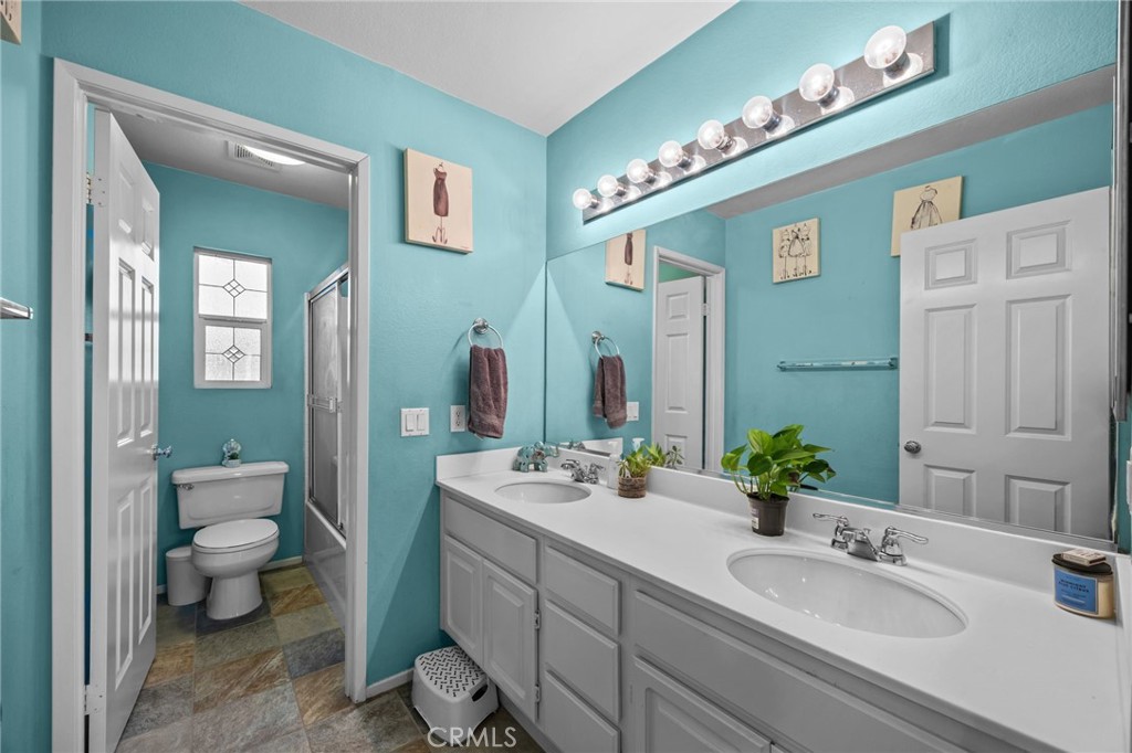 150 Saddleback Way Perris, CA 92570 - Photo 23 of 46 a bathroom with a granite countertop sink mirror and toilet