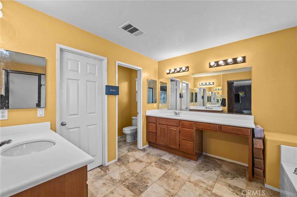 150 Saddleback Way Perris, CA 92570 - Photo 29 of 46 a spacious bathroom with a granite countertop sink and a bathtub