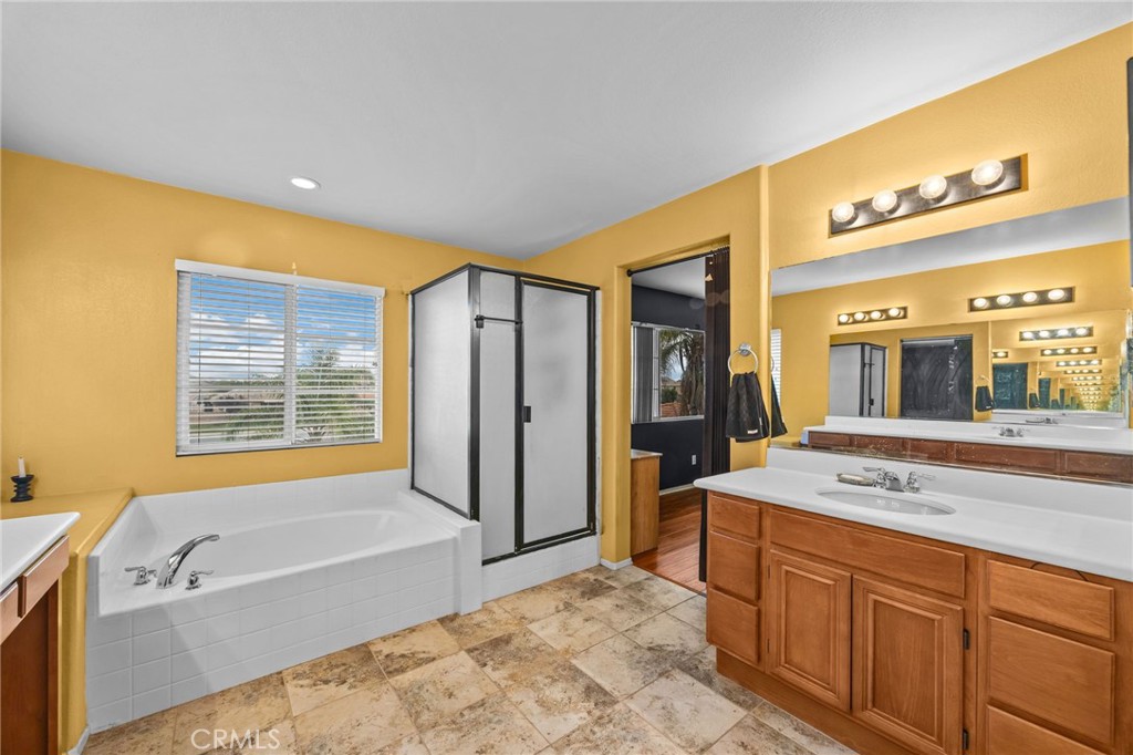 150 Saddleback Way Perris, CA 92570 - Photo 30 of 46 a spacious bathroom with a tub sink and mirror