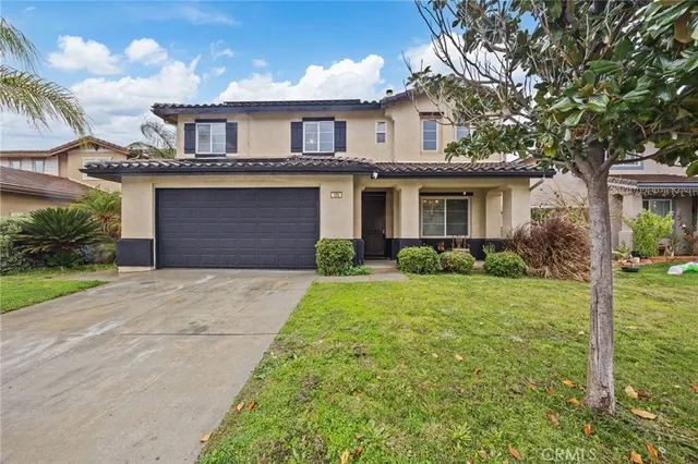 a front view of a house with a yard and garage