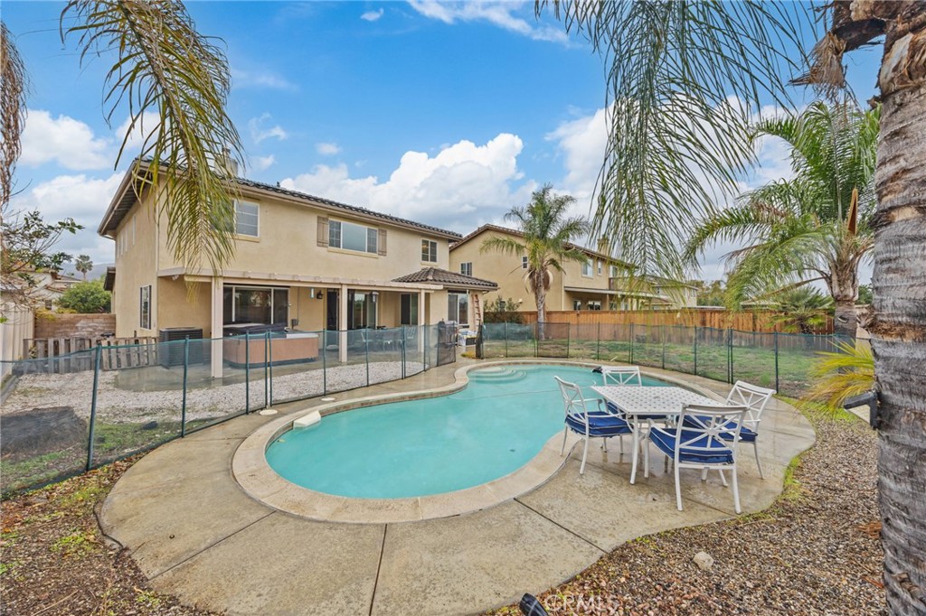 150 Saddleback Way Perris, CA 92570 - Photo 36 of 46 a view of a house with a swimming pool and sitting area
