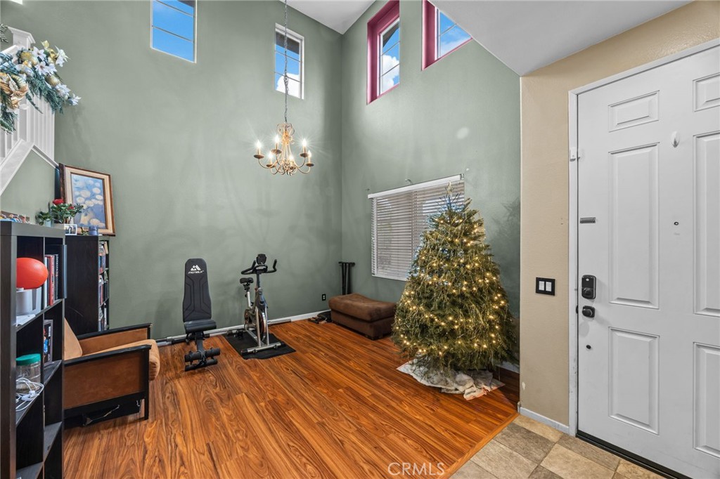 150 Saddleback Way Perris, CA 92570 - Photo 7 of 46 a room with gym equipment and a chandelier