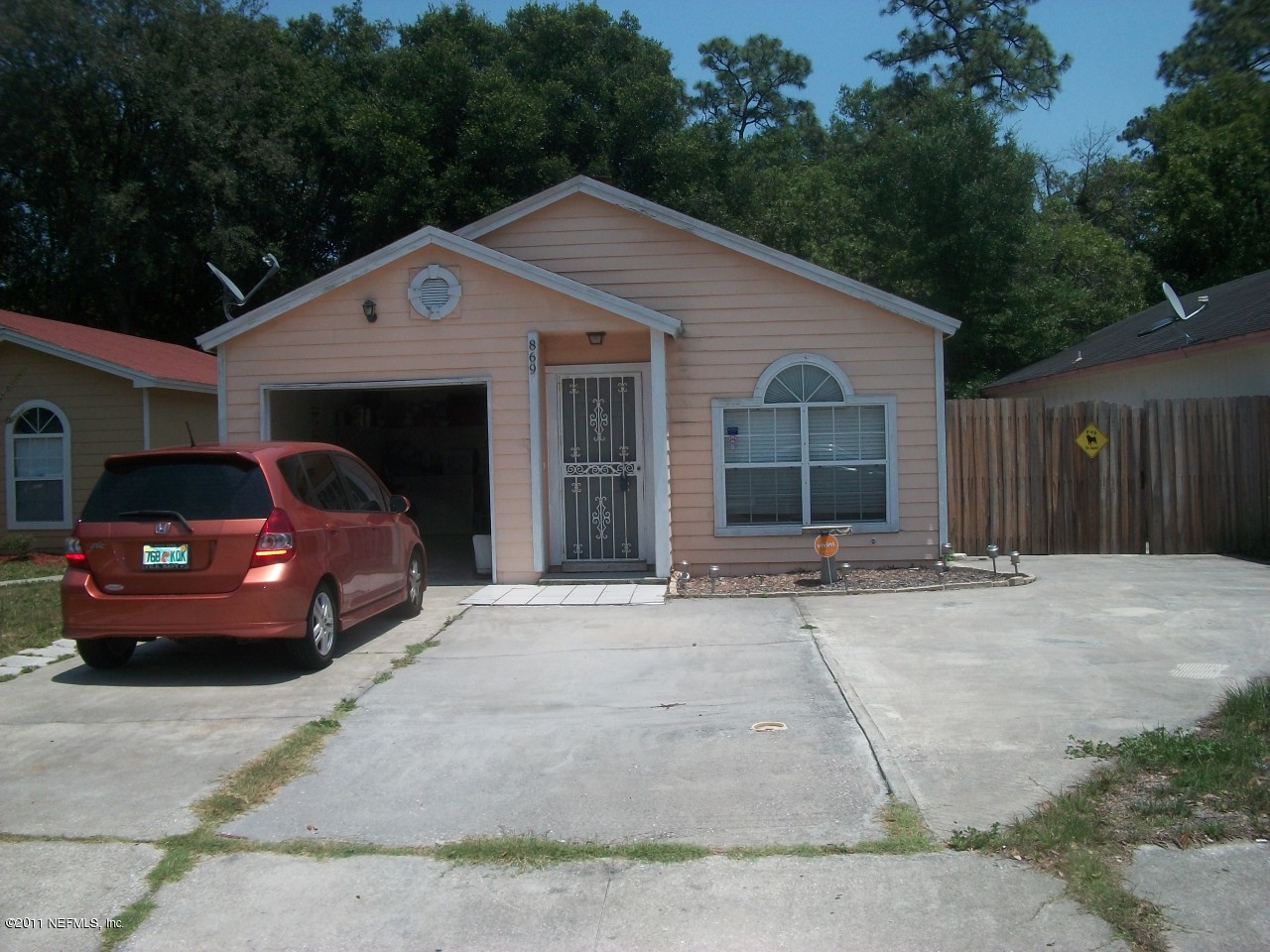 869 Jackson Road Jacksonville, FL 32225 - Photo 2 of 10 a front view of a house with a yard and garage