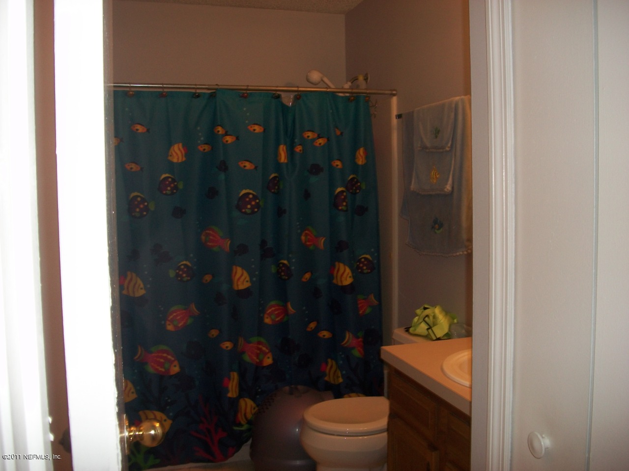 869 Jackson Road Jacksonville, FL 32225 - Photo 8 of 10 a bathroom with a toilet and a shower curtain