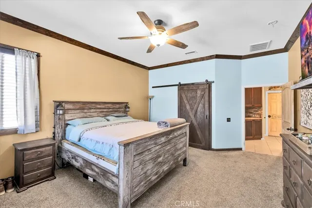 a bed room with a bed and a ceiling fan
