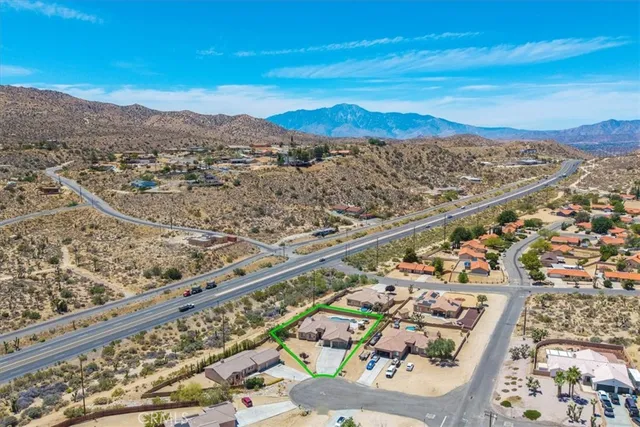 an aerial view of residential houses with outdoor space