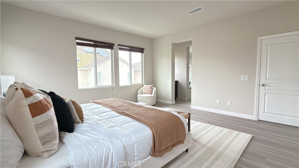 7833 Wild Rye Street Chino, CA 91708 - Photo 15 of 44 a bedroom with a bed and wooden floor