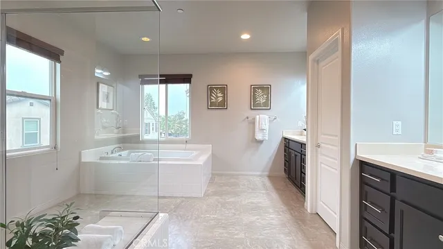 a spacious bathroom with a tub shower and sink