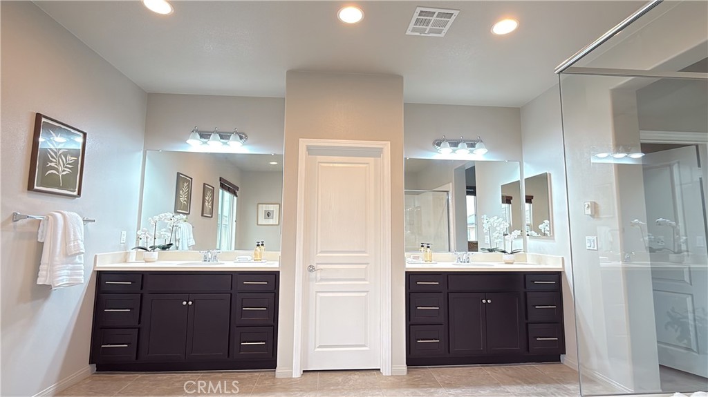 7833 Wild Rye Street Chino, CA 91708 - Photo 19 of 44 a bathroom with a sink vanity and a mirror