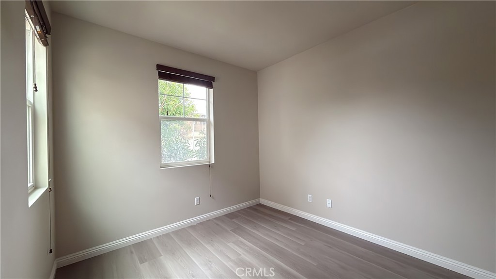 7833 Wild Rye Street Chino, CA 91708 - Photo 22 of 44 an empty room with wooden floor and windows