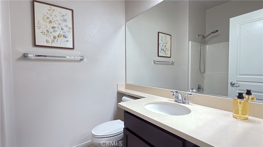 7833 Wild Rye Street Chino, CA 91708 - Photo 31 of 44 a bathroom with a granite countertop sink and a toilet