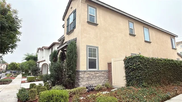 a view of a white house with a outdoor space