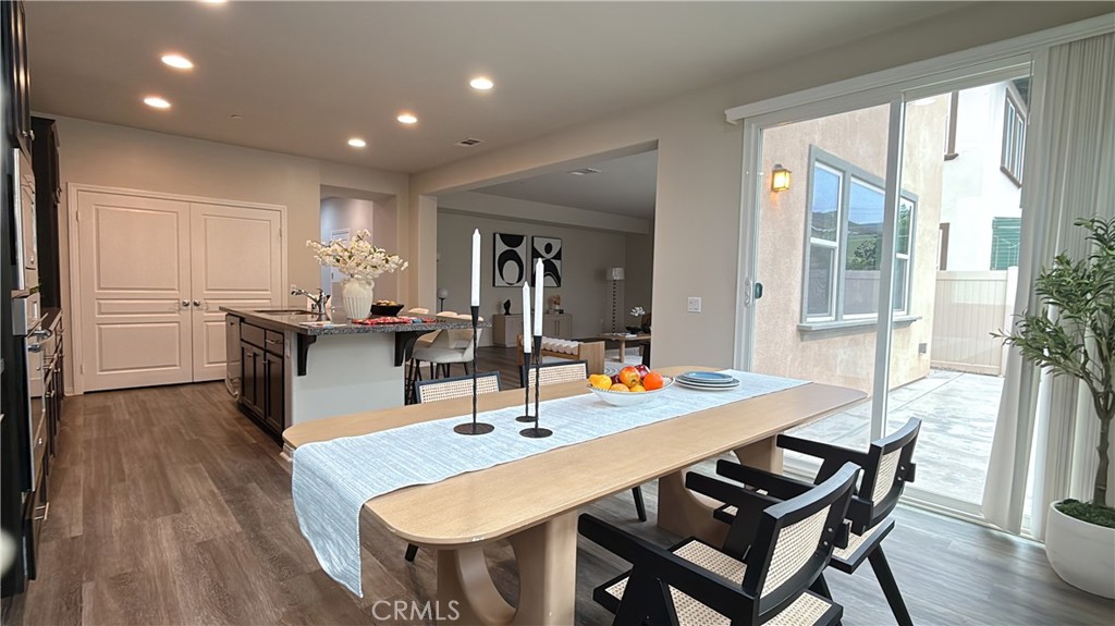 7833 Wild Rye Street Chino, CA 91708 - Photo 6 of 44 a view of a dining room with furniture and wooden floor