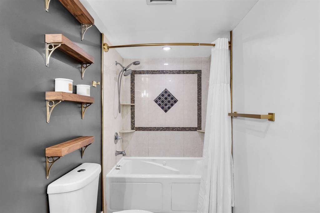 4200 Hillcrest Drive, Unit 711 Hollywood, FL 33021 - Photo 18 of 37 a bathroom with a shower a toilet and a tub